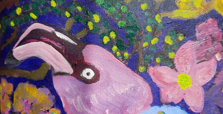 Head of a flamingo, background with tree branch and flowers